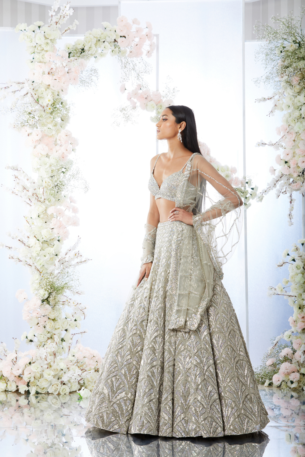 IVORY WHITE SHIMMERY COCKTAIL LEHENGA SET WITH A HAND EMBROIDERED MIRROR  WORK BLOUSE PAIRED WITH A MATCHING FRILL DUPATTA AND SILVER EMBELLISHMENTS.  - Seasons India